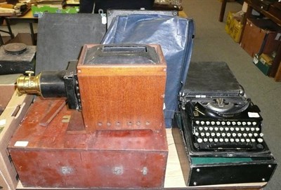 Lot 724 - Two Portable Gramophones; and Two Manual Typewriters, cased and a Magic Lantern (5)