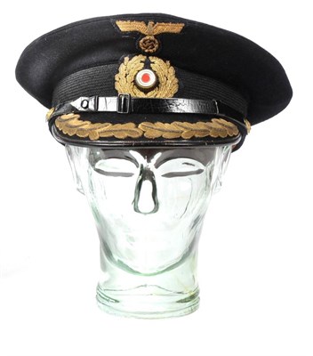 Lot 299 - A German Third Reich Kriegsmarine Officer's Blue Wool Visor Cap, with gold bullion thread...