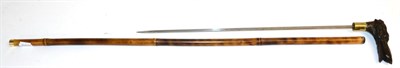 Lot 378 - A Bamboo Swordstick, with 53cm square tapering steel blade, brass collar, the dark brown...