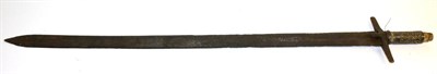 Lot 441 - An 18th Century Sudanese Kaskara, the 92.5cm broad double edge steel blade with a narrow fuller...