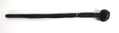 Lot 452 - An Early 20th Century Zulu Knobkerrie, the fluted globular head inset with two metal studs, the...