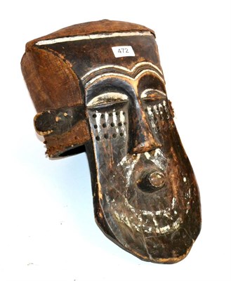 Lot 472 - A Kuba DRC, Wood Helmet Mask, the skull covered in coarse woven fabric, rectangular forehead,...