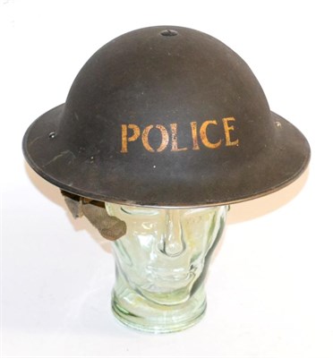 Lot 158 - A Second World War Brodie Helmet to the Police, with black oil cloth liner, the liner straps...