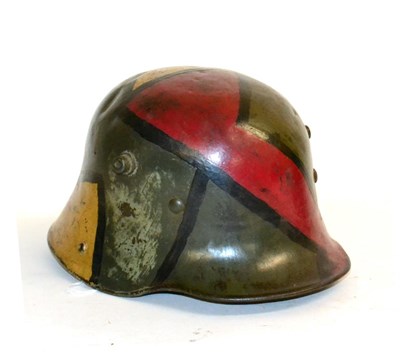 Lot 168 - An Imperial German M16 Army Helmet, with later camouflage paint, with three part padded leather...