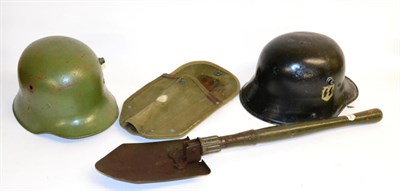 Lot 171 - A German M18 Combat Helmet, with later SS decal and leather liner; another, with green paint, lacks