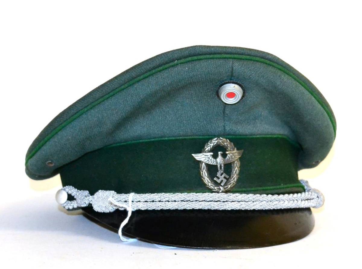 Lot 198 - A German Third Reich Schutzpolizei Officer's Visor Cap, in green twill with green velvet centreband