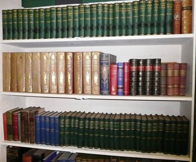 Lot 793 - The Works of Charles Dickens and other volumes on three shelves