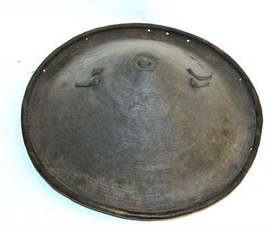 Lot 300 - A 19th Century Ethiopian Elephant Hide Shield, of deep convex circular form, with central...