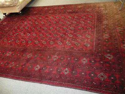 Lot 812 - Afghan Carpet Afghan Turkestan The blood red field with five rows of guls enclosed by multiple...