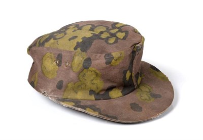 Lot 241 - A German Third Reich Waffen SS Camouflage M43 Ski Cap, reversible, the cut-out vent holes with...