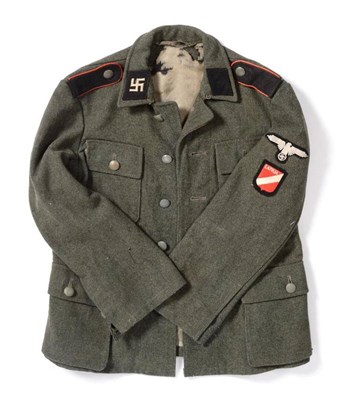 Lot 242 - A Latvian Waffen-SS Man's Model 1943 Tunic, in field grey wool, with Latvian swastika collar...