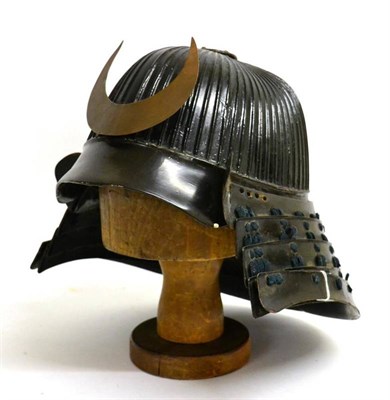 Lot 266 - An Early/Mid 19th Century Japanese Kabuto, of black lacquered metal, the shallow oval fluted...