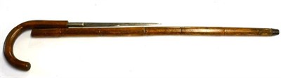 Lot 393 - An Early 20th Century Bamboo Dagger Stick, the 27cm fullered steel blade etched TOLEDO, with curved