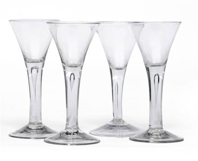 Lot 19 - A Group of Four Wine Glasses, circa 1750, each with drawn trumpet bowl and teared plain stems,...