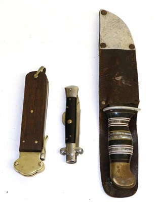 Lot 402 - A US Fighting Knife, with 13cm clip point steel blade, the hilt with grip made up with bands of...