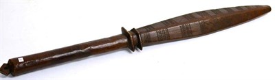 Lot 411 - A Solomon Islands War Club, the elongated diamond section head carved with narrow bands of...