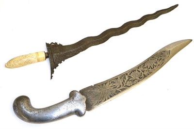 Lot 420 - A 19th Century Malayan Kris, with 35cm ten lock pamor steel blade, the ivory grip carved with a...