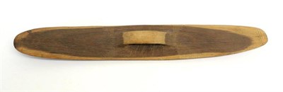 Lot 430 - An Australian Aboriginal Parrying Shield, of narrow curved oblong form, the fascia carved with...