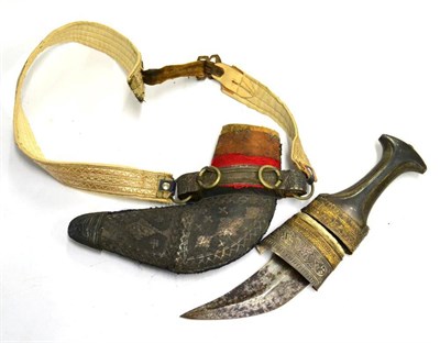 Lot 435 - An Arab Jambiya, the 14cm curved blade with raised medial ridge, waisted horn grip, the wood...