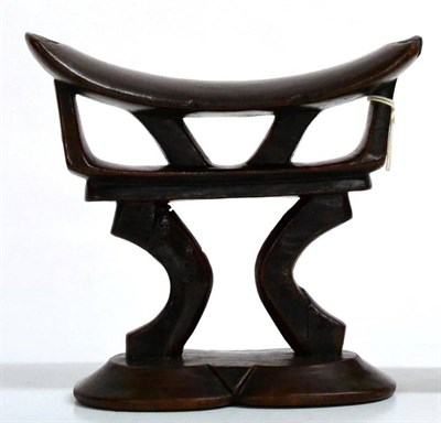 Lot 450 - A Tsonga (Southern Africa) Carved Wood Headrest, the dished top with geometric carved ends on...