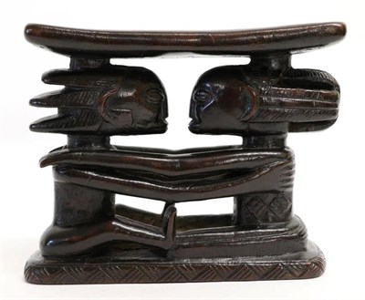 Lot 457 - A Luba Headrest, DCR, with rectangular cushion supported on the heads of a couple, seated...