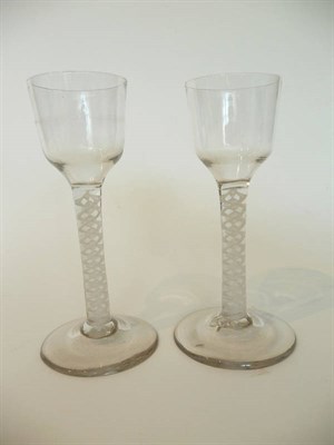 Lot 26 - Two Similar Wine Glasses, circa 1770, the ogee bowls on double series opaque twist stems comprising