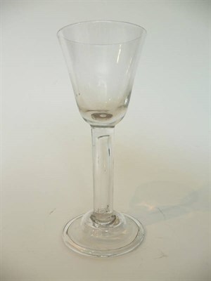 Lot 30 - A Wine Glass, circa 1750, the round funnel bowl on an hollow cylindrical stem with domed and folded