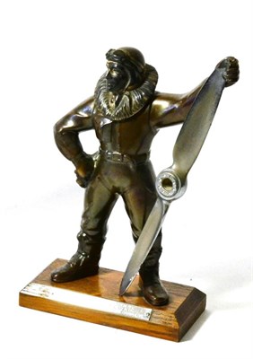 Lot 143 - A Patinated Spelter Table Lighter, Cast as an Aviator, standing, leaning on an aeroplane propellor