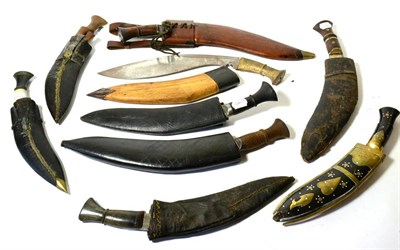 Lot 395 - A Nepalese Kukri, the 33cm curved steel blade with notch at the ricasso and double fullers...