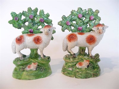 Lot 75 - A Pair of Ralph Salt Pearlware Models of Sheep, circa 1830, each standing before bocage on...
