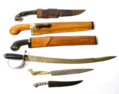 Lot 396 - An Indonesian Golok, the 33.5cm clip-point curved steel blade with inlaid brass line to the...