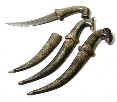 Lot 427 - Three Indian Small Daggers, each with faux damascined curved steel blade, the hilt modelled as...