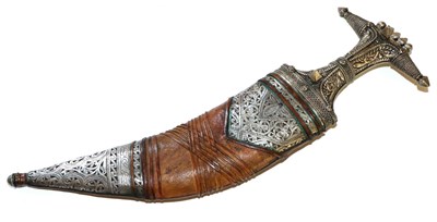 Lot 429 - An Arab Jambiya, with foliate embossed silver covered hilt and leather scabbard with similar...