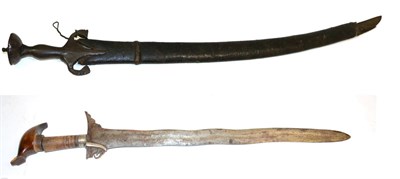 Lot 430 - A 19th Century Indian Talwar, the 75cm single edged curved steel blade with a narrow fuller running