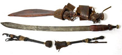 Lot 432 - A Tuareg Sword, the 58cm single edge steel blade with two narrow fullers to the back edge and...