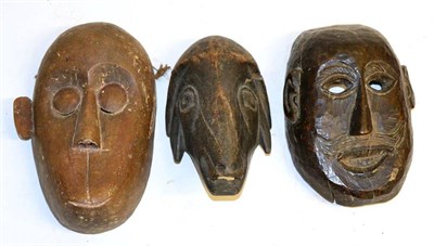 Lot 439 - A Carved Wood Mask, possibly Alaskan, as a man with twisted nose and mouth, the reverse set...