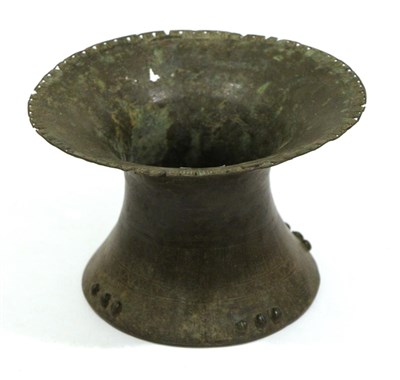 Lot 447 - An Early Ashante Bronze Vessel, of waisted cylindrical form, the flange rim pierced and stamped...