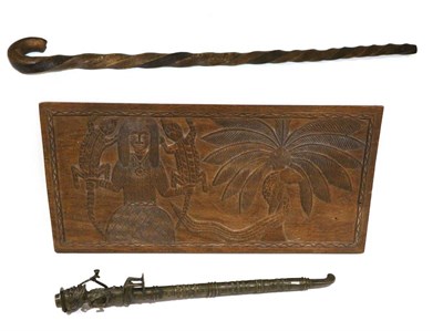 Lot 448 - A Benin, Nigeria Wood Plaque, of horizontal rectangular form, carved with a figure of a man...