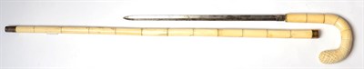 Lot 240 - A 19th Century Ivory Sword Stick, with 39cm double edge diamond shape steel blade, curved...