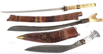 Lot 261 - A Nepalese Gurkha Kukri, the 37cm unmarked steel blade with two narrow fullers to the back...