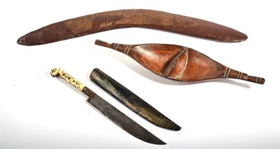Lot 262 - An Australian Aboriginal Boomerang, one side carved with an Emu on a roughened field, 51cm; a South