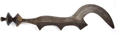 Lot 281 - A Ngombe Executioner's Sword, Congo, the 48cm fancy sickle shape steel blade decorated with incised