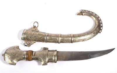Lot 285 - An Arab Jambiya, with 20cm curved double edge steel blade, the white metal hilt and curved scabbard