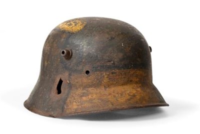 Lot 217 - A First World War German-made Turkish Steel Helmet, with camouflage paint divided by black...