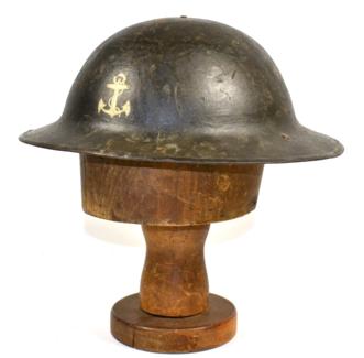 Lot 218 - A First World War Brodie Helmet, the front painted with a fouled anchor for the Royal Naval...