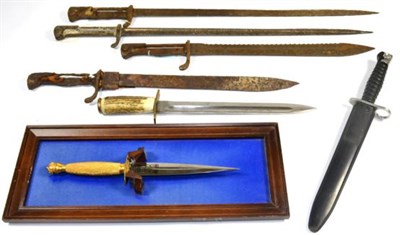 Lot 339 - A Swiss SIG Stgw 1957 Pattern Bayonet, with black plastic grip and scabbard; a Trench Knife,...