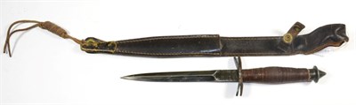 Lot 345 - A V-42 Type Fighting Knife, the 18.5cm blackened steel blade with a ribbed thumb rest at the...