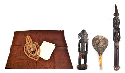 Lot 380 - A Papua New Guinea Flute Stopper, of red clay modelled as a human mask with inset cowrie shell...