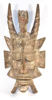 Lot 396 - A Senufo Wood Mask, Ivory Coast, with wryen fluted horns centred by the figure of a Kalao bird,...