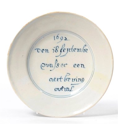 Lot 179 - A Dutch Delft Earthquake Commemorative Plate, dated 1692, inscribed in blue Den 18 Septembe...